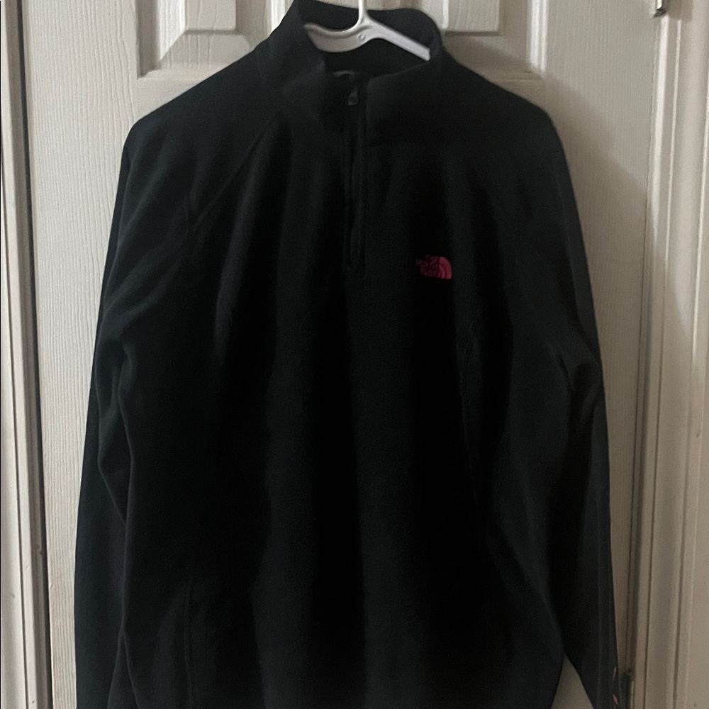 TNF quarter zip in black with a pink breast cancer awareness logo on left sleeve